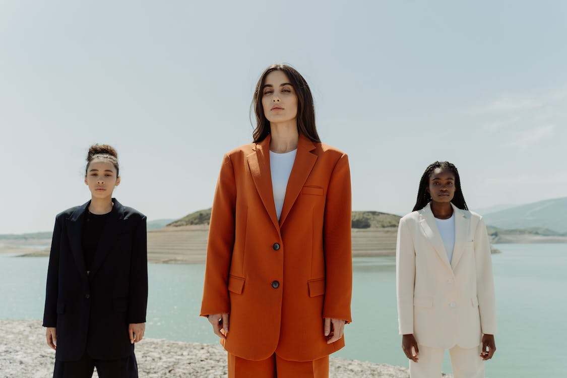 3 women in a suit; black-orange-white