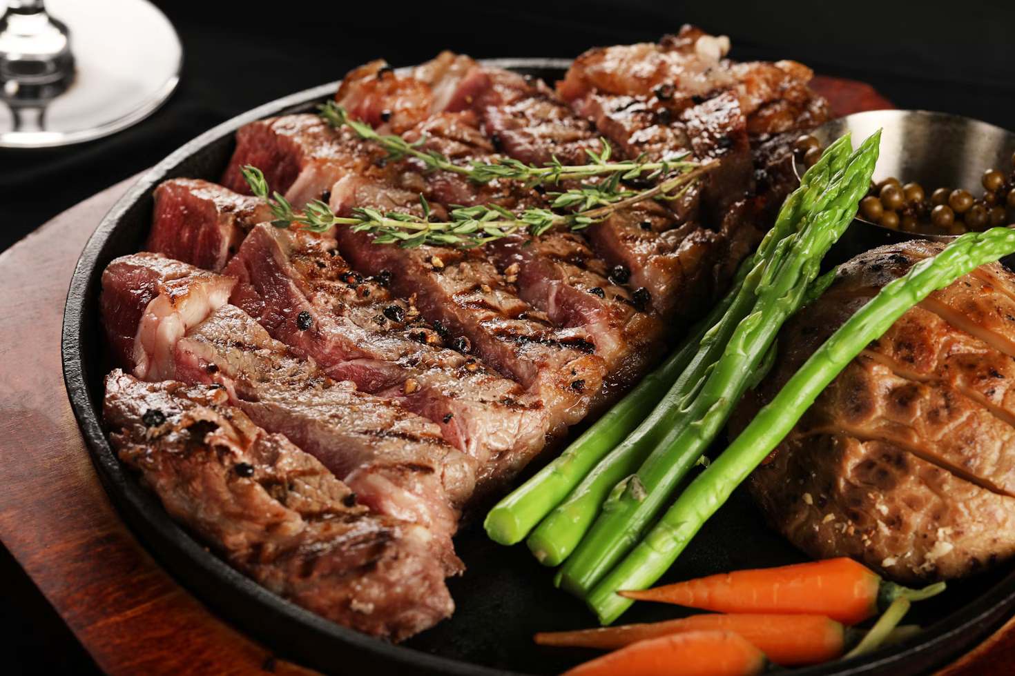A plate of stake with asparagus and carrots; a close-up photo