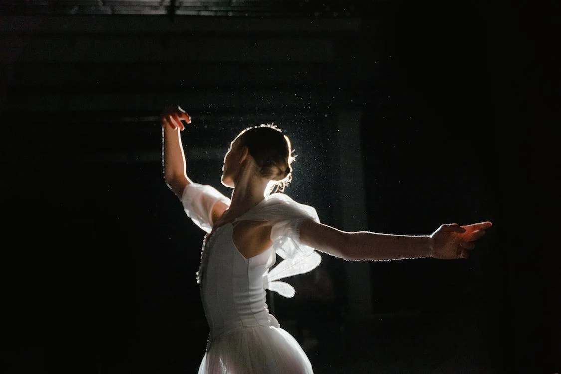A woman in white dress dancing