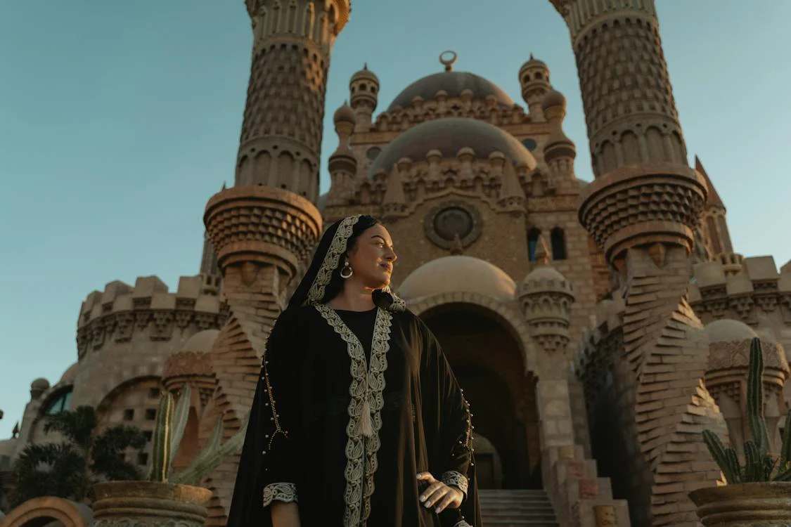 A woman wearing black abaya with white patterns