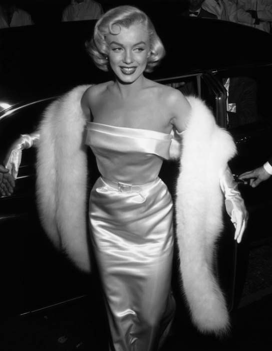 Marilyn Monroe wearing silk dress and a faux on her arms