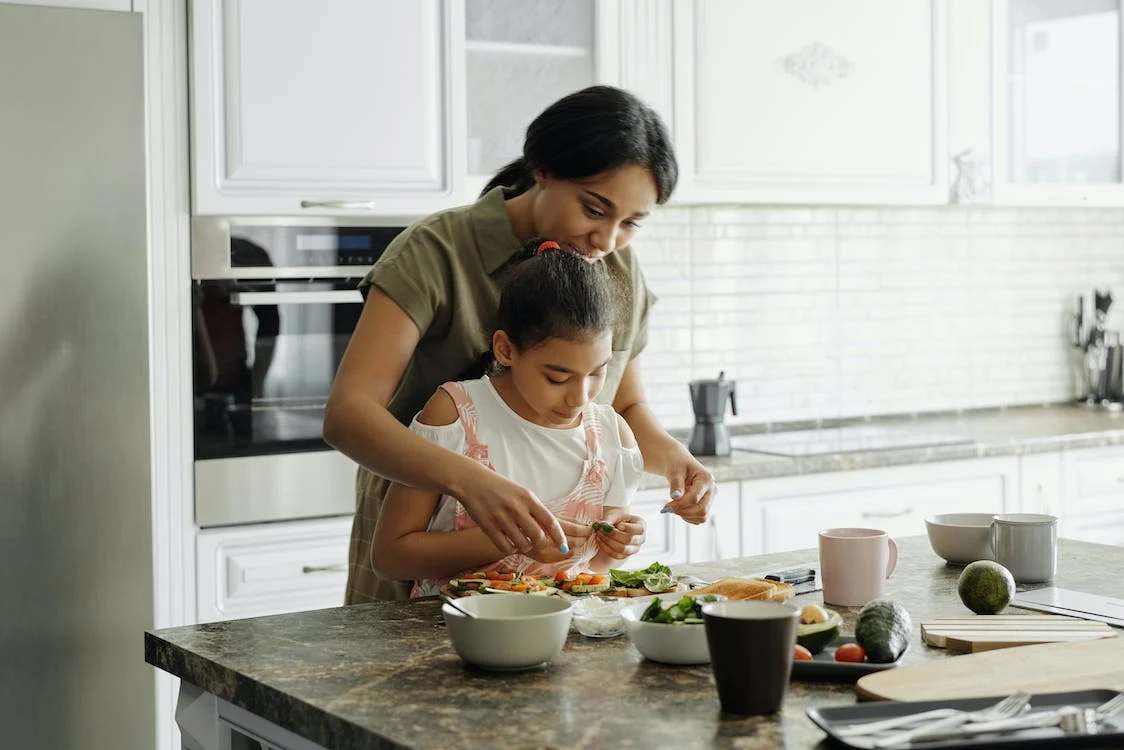 Mother and daughter preparing food together