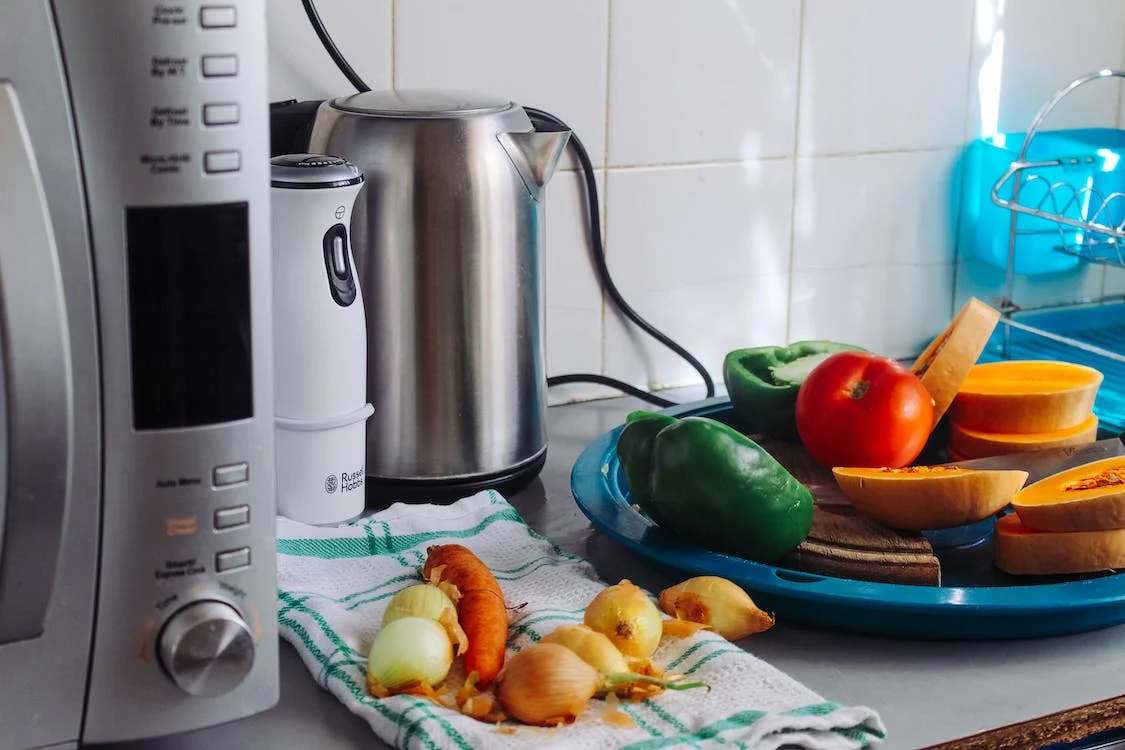Vegetables next t an electric kettle