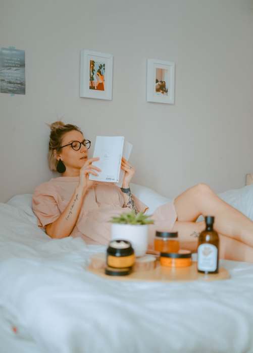 Woman reading a book in bed