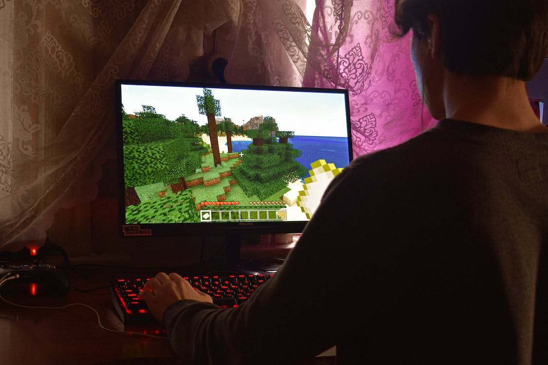 A guy playing a game on his computer