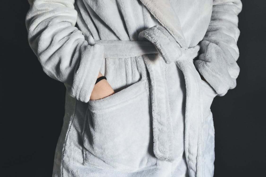 Close-up of a person wearing a white bathrobe