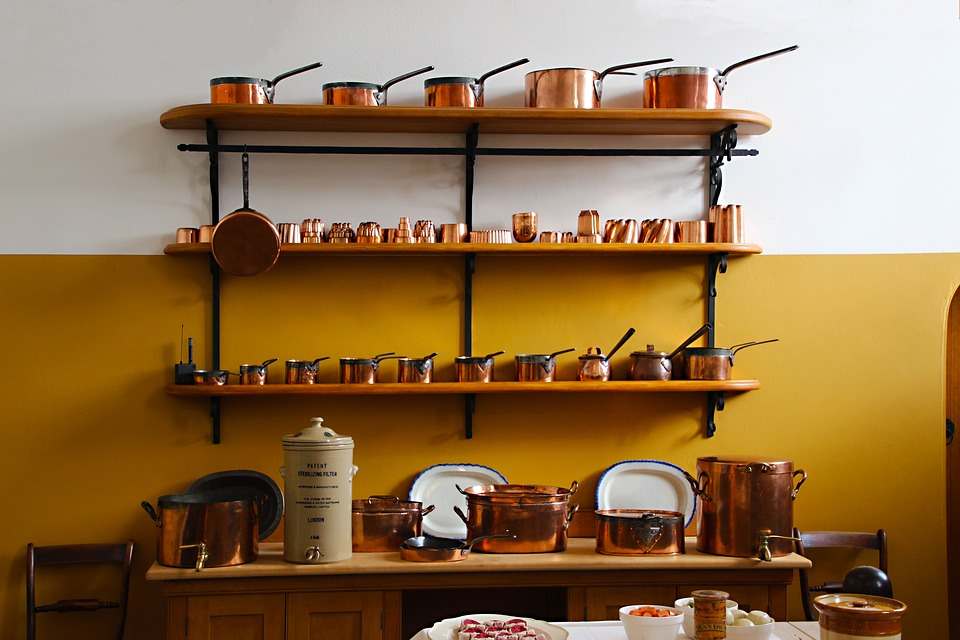 Different kinds of copper cookware in a kitchen