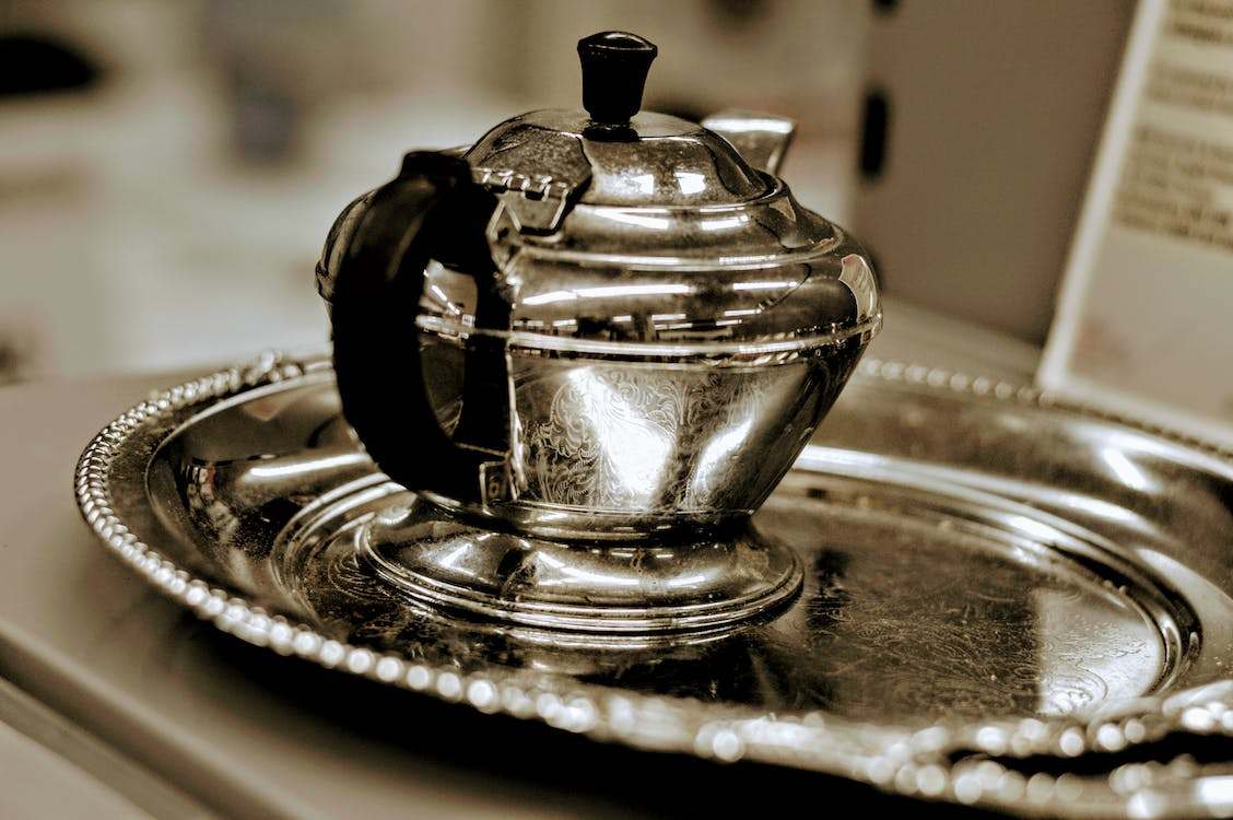 Silver teapot on silver tray