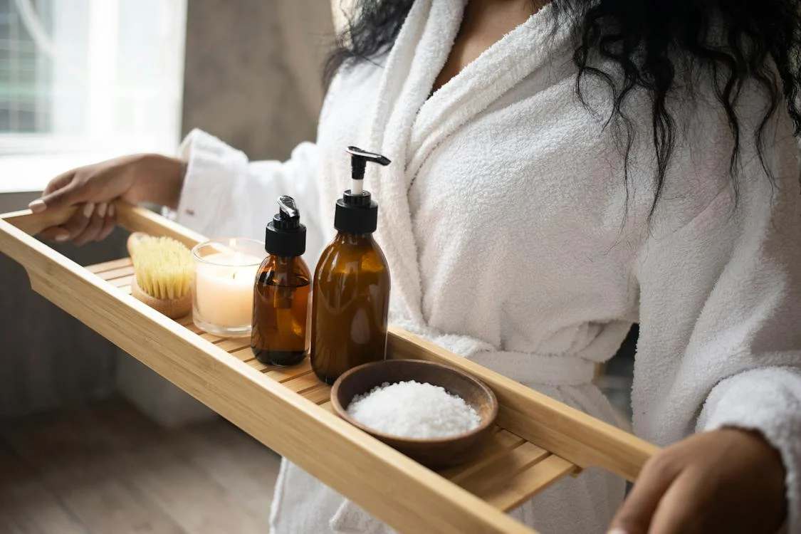 Woman holding a tray of spa products