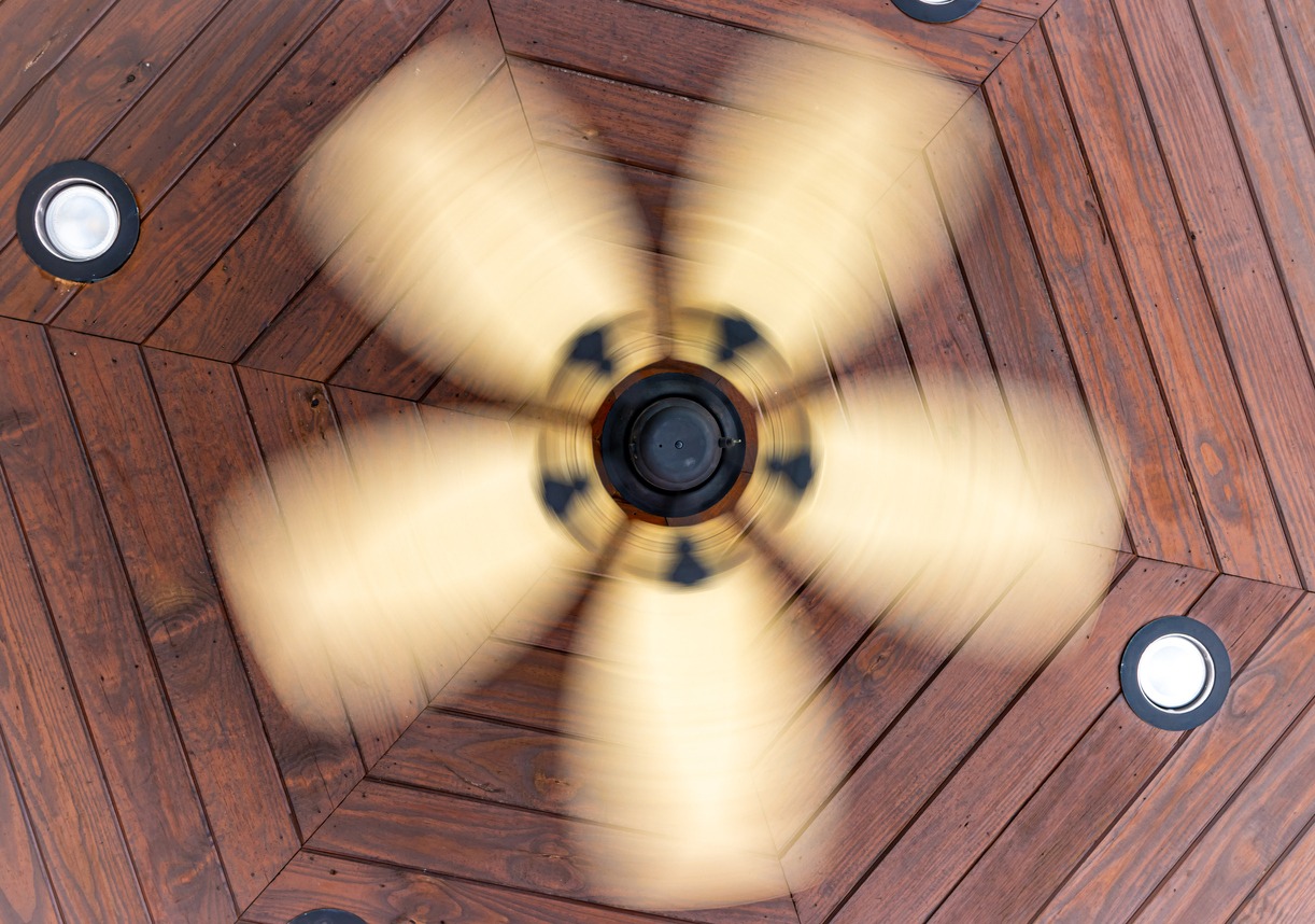 Ceiling fan spinning in a porch stock photo