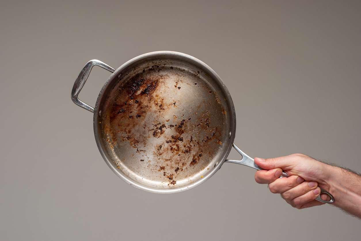 Dirty oily burnt metal frying pan
